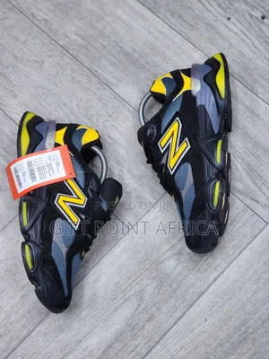 New Balance 9060 Sneakers In A Black, Grey, And Yellow
