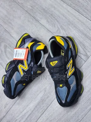 New Balance 9060 Sneakers In A Black, Grey, And Yellow