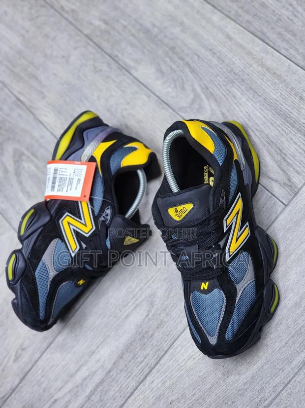 New Balance 9060 Sneakers In A Black, Grey, And Yellow