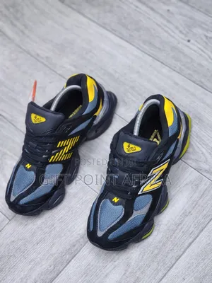 New Balance 9060 Sneakers In A Black, Grey, And Yellow