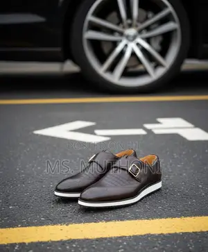 Monk Strap Dress Shoes With a White Sole and a Gold-Tone Buckle.