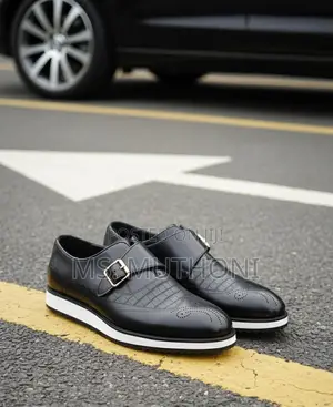 Monk Strap Dress Shoes With a White Sole and a Gold-Tone Buckle.