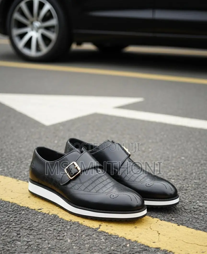 Monk Strap Dress Shoes With a White Sole and a Gold-Tone Buckle.