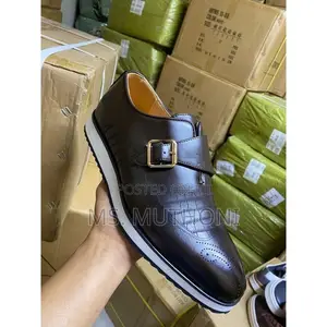 Monk Strap Dress Shoes With a White Sole and a Gold-Tone Buckle.