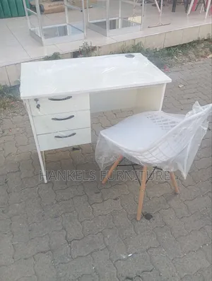 All-White Office Desk With Mesh Eames Chair