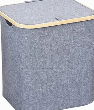 Collapsible Fabric Laundry Hampers With Bamboo-Trimmed Lids.