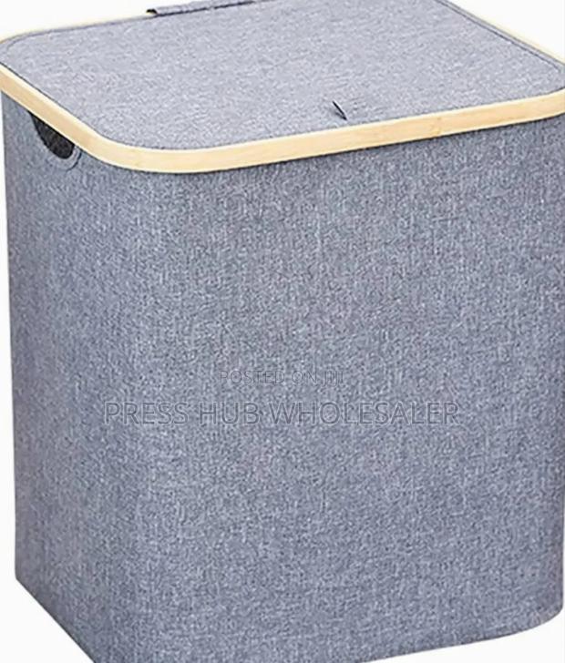 Collapsible Fabric Laundry Hampers With Bamboo-Trimmed Lids.