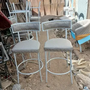 Bar Stools Enhanced With Gold Buttons.