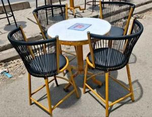 Outdoor Woven Chairs With Gold Metal Table.