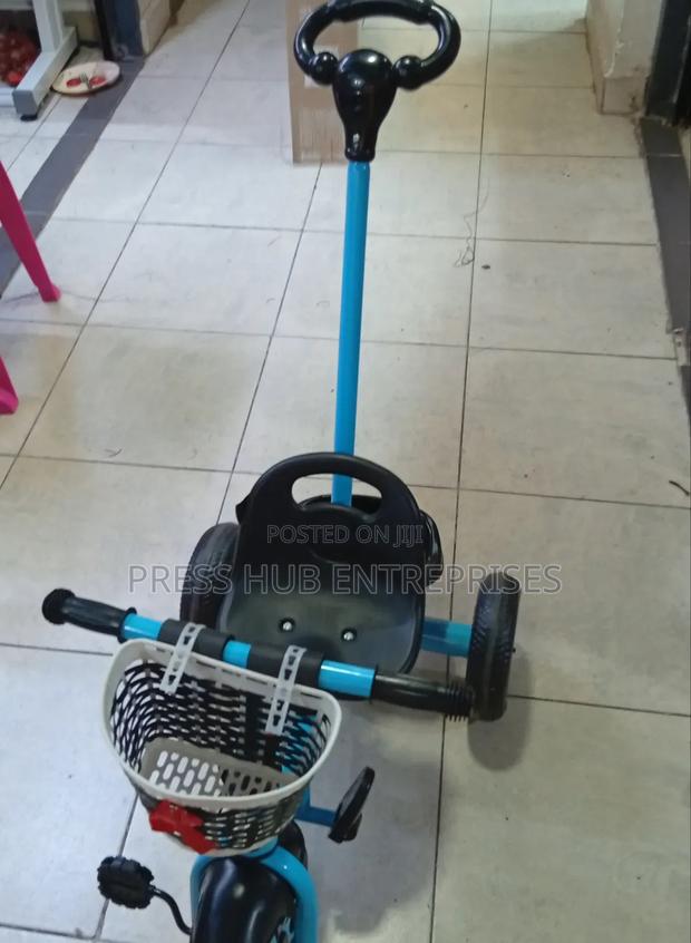 Baby Tricycle With a Parent Handle and a Front Basket. - main view