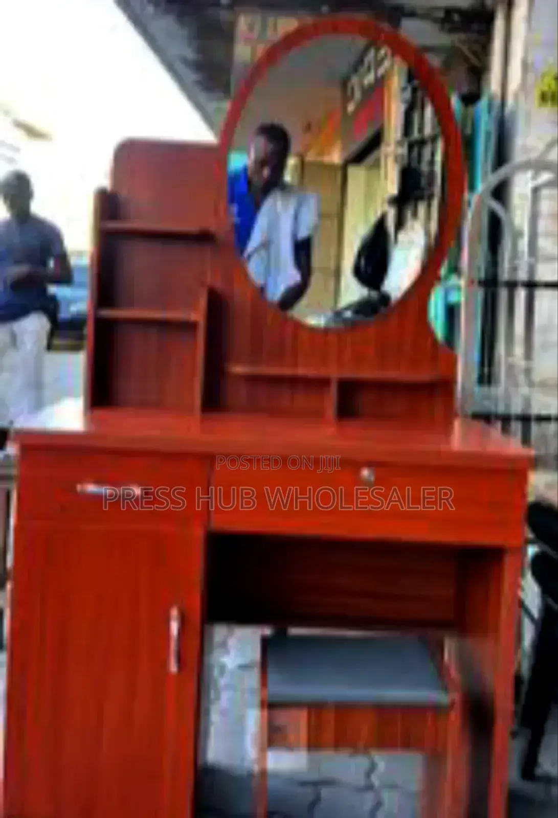 Dressing Table With a Mirror and a Cushioned Stool.