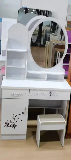 Dressing Table With a Mirror and a Cushioned Stool. 