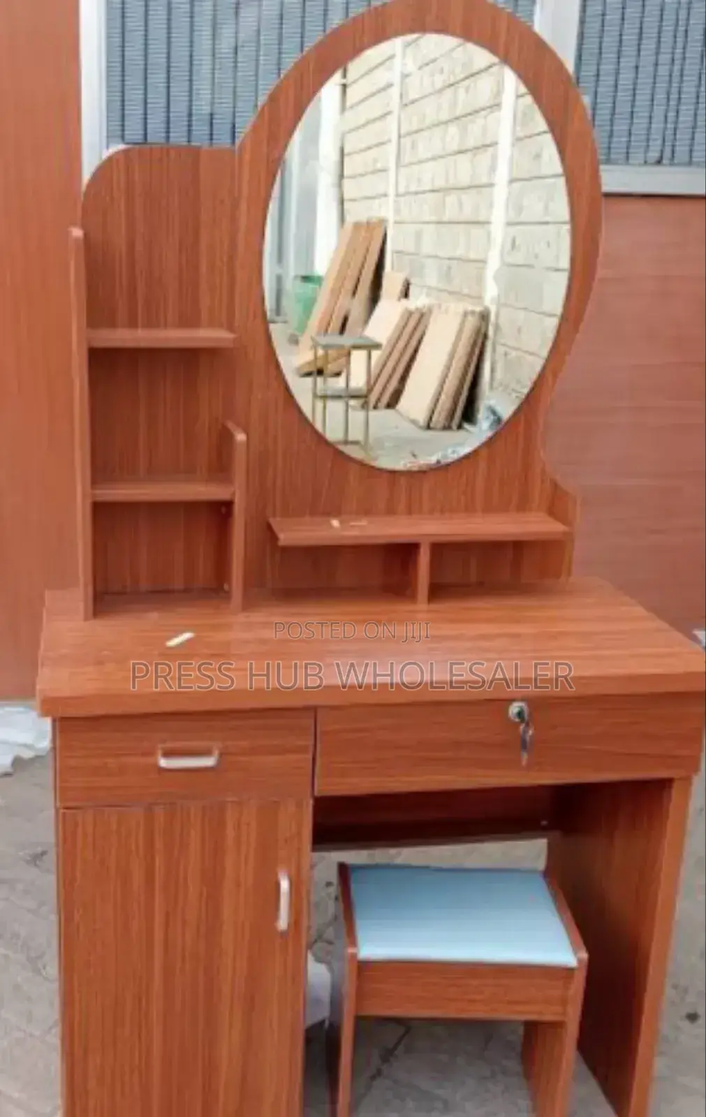 Dressing Table With a Mirror and a Cushioned Stool. : 
