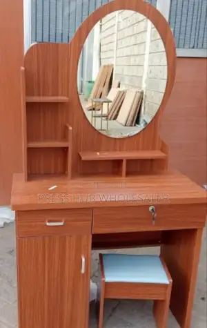 Dressing Table With a Mirror and a Cushioned Stool. : 