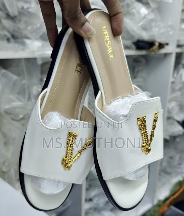 Versace Flat Sandals With a Gold-Tone v Logo Detail.