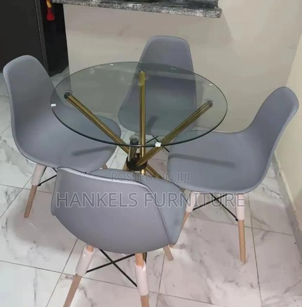 Round Glass Dining Table With Gray Eames Chairs – Modern Elegant