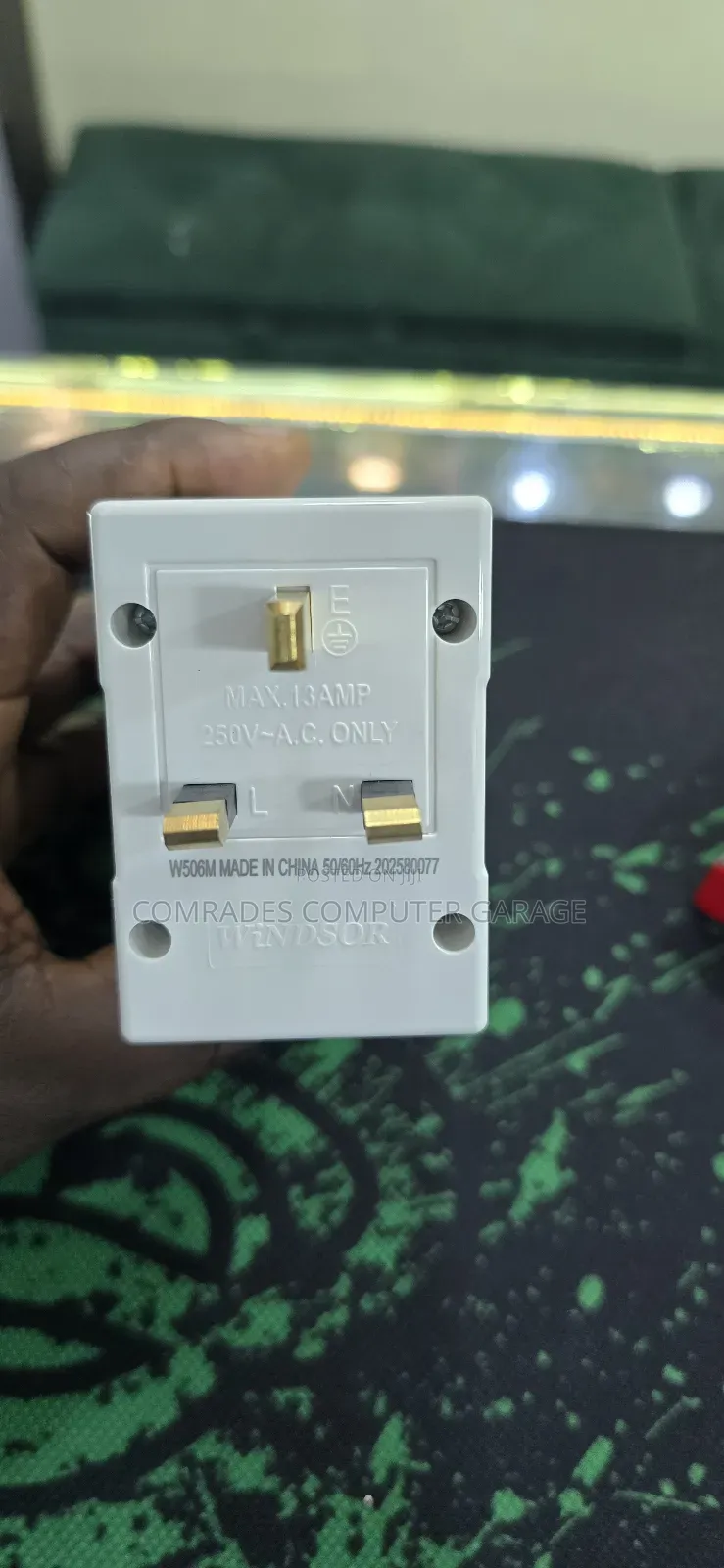3-Pin Uk Multiplug Adapter Which Also Functions Voltage Protector.