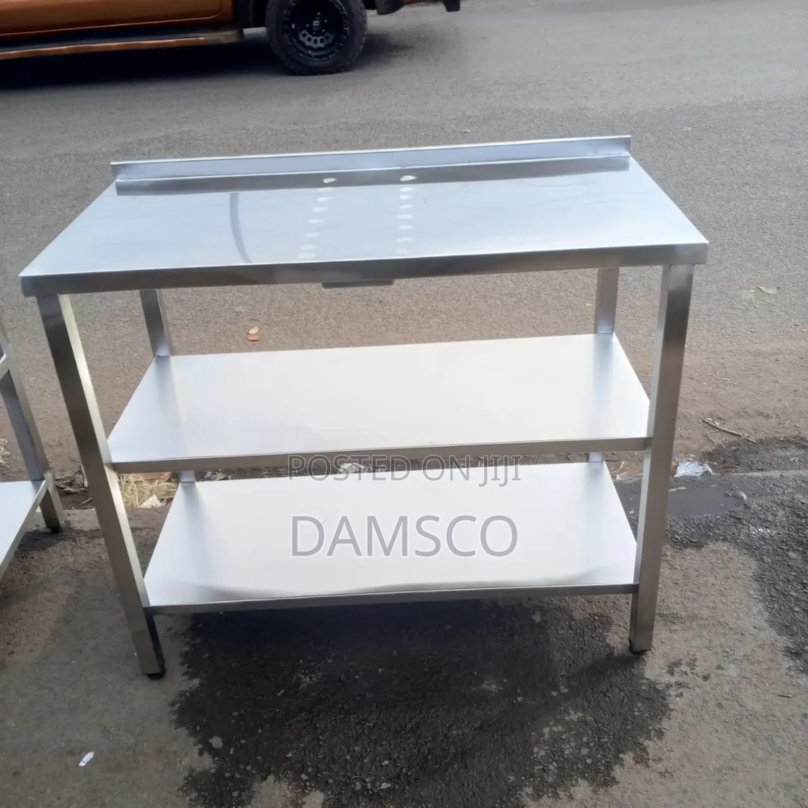 A Three-Tier Stainless Steel Working Table
