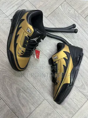 Air Jordan Unisex 3 Retro Sneakers In A Black And Gold Colorway.