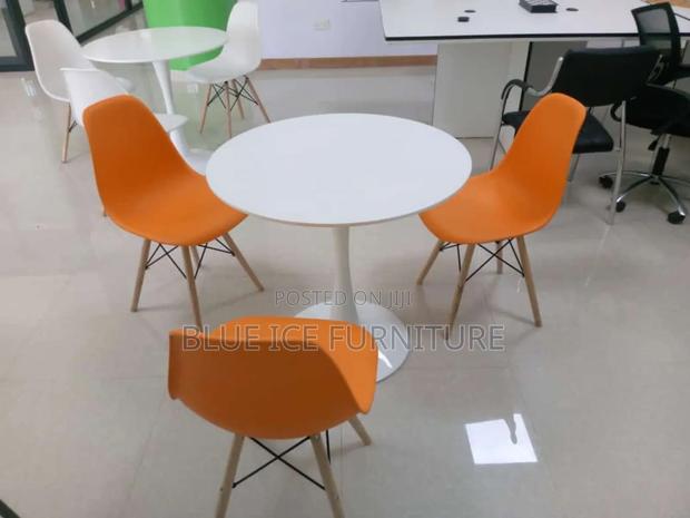 White Coffee Dining Table With Orange Eame Chair - main view