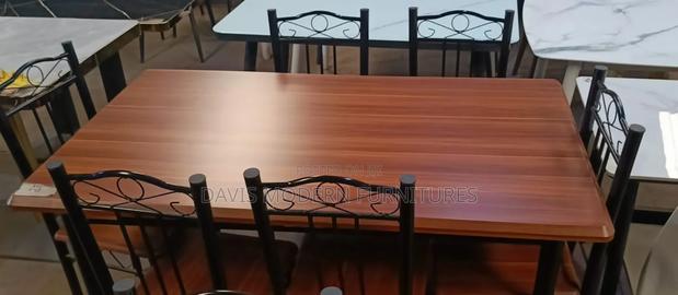 Dark-Brown Wooden Table With 6 Black Chairs