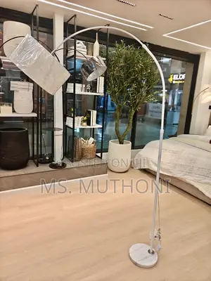  Modern Arc Floor Lamp Featuring a Curved Metal Arm and a Heavy