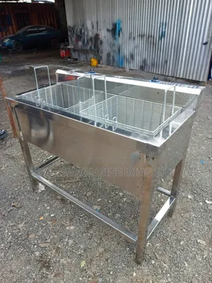 Commercial Stainless Steel Double Deep Fryer With a Stand.