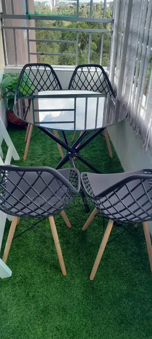 Black Stand Clear Round Table and Mesh Eames Chairs