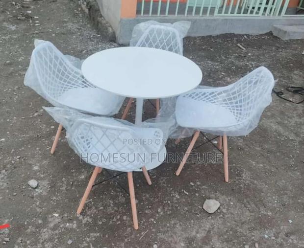 All White Round Eames Table and White Eames Chairs