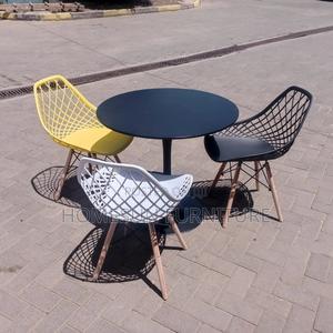 Black Round Table and Mesh Eames Chairs