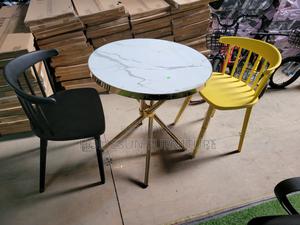 Round Dining Table and Plastic Chairs