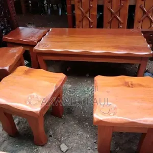 A Set Of Coffee Table And Four Stools