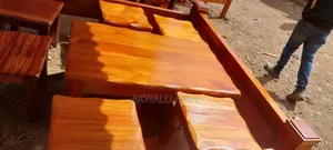 A Set Of Coffee Table And Four Stools
