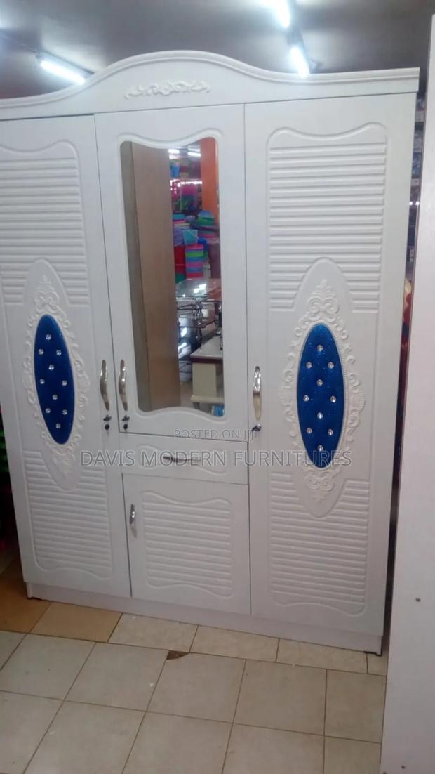 White Three Door Cabinet With Decorations