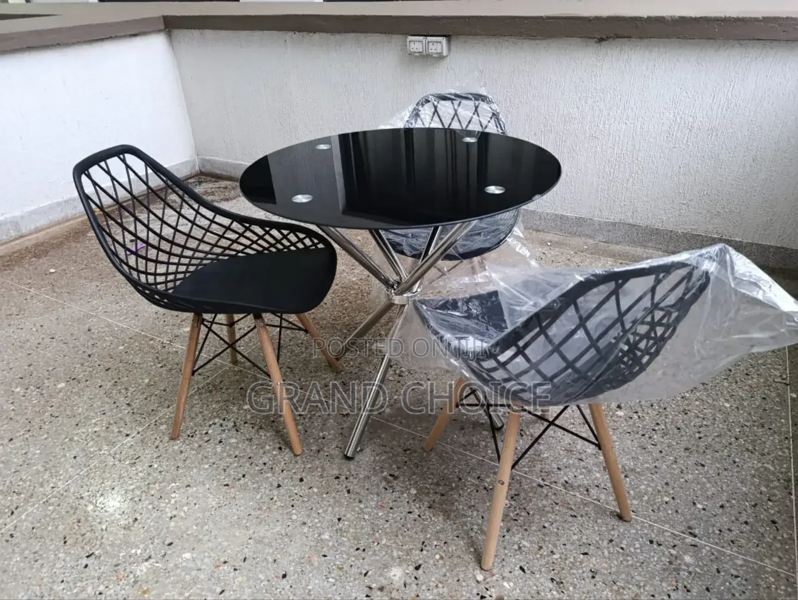 Glass Dining Table With Mesh Eames Chairs