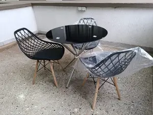 Glass Dining Table With Mesh Eames Chairs