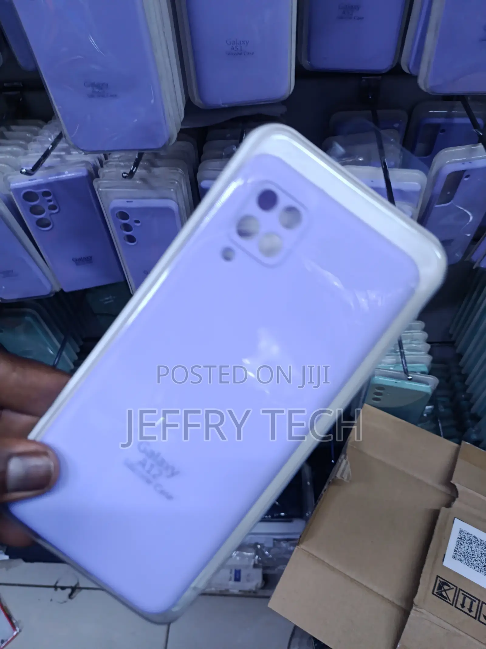 Samsung Galaxy A12 Smartphone in a Light Purple Protective Case.