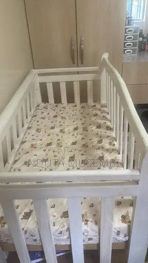 Baby Cot With a Mattress, Duvet, and Two Duvet Covers