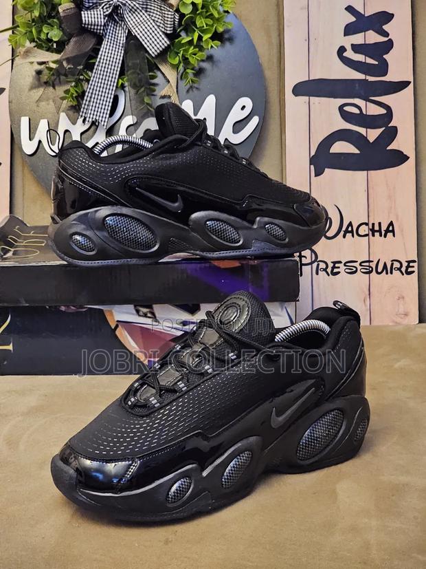 All Black Nocta Glide Sneakers