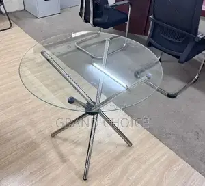 Modern Round Glass Coffee Table With A Metal Cross Base