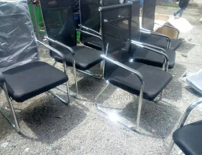A Black Mesh Visitors Office Chair With Cantilever Frame