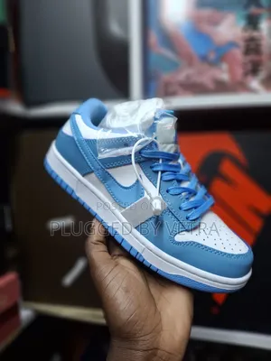 Nike Sb Dunk Low Sneakers in the "Unc" or "University Blue" Colorway.