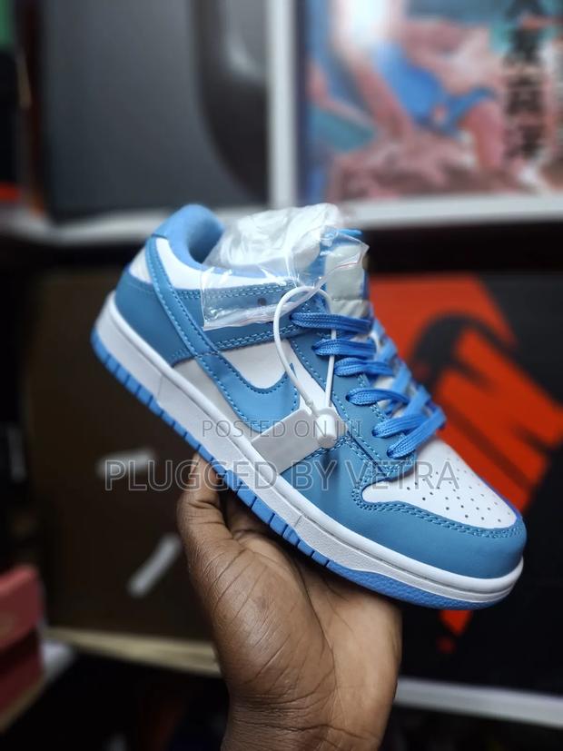 Nike Sb Dunk Low Sneakers in the "Unc" or "University Blue" Colorway.
