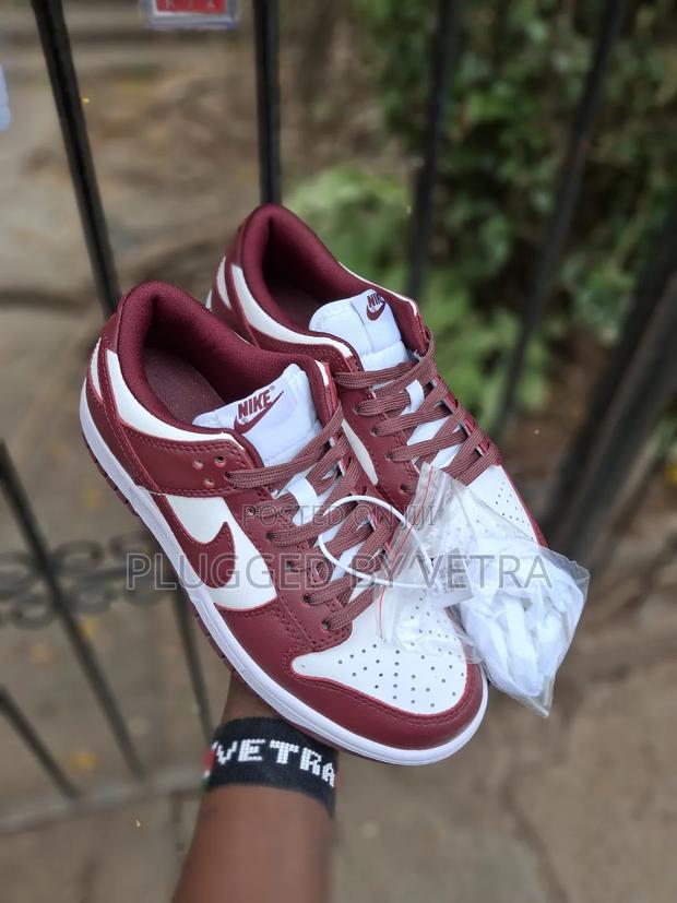 Nike Dunk Low in the 'Team Red' Colorway.