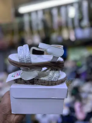 Glittery White Girl's Sandals Featuring a Floral Embellishment