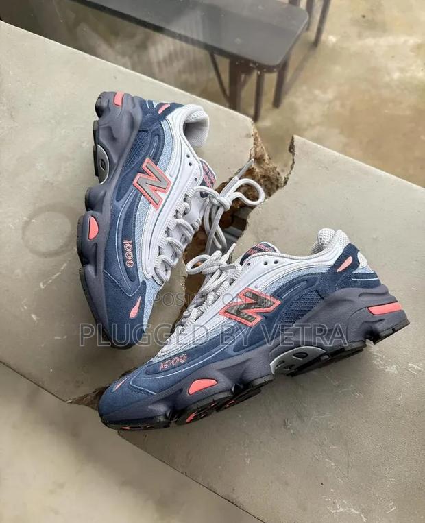 New Balance 1000 in the Navy Grey With Coral Accents Colorway.