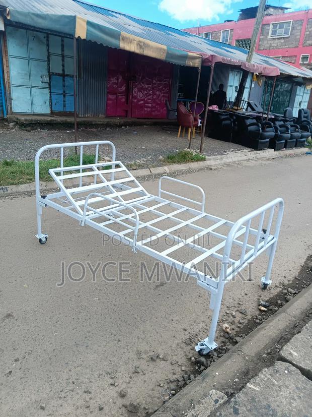 Hospital Bed With Caster Wheels and Coated White Frame