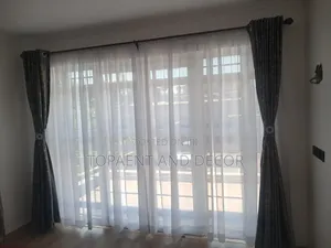 Gray Curtains With Gold Patterns and Sheers