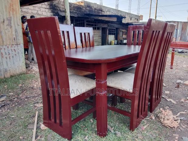 A Dining Table With 6 Chairs Brown in Colour
