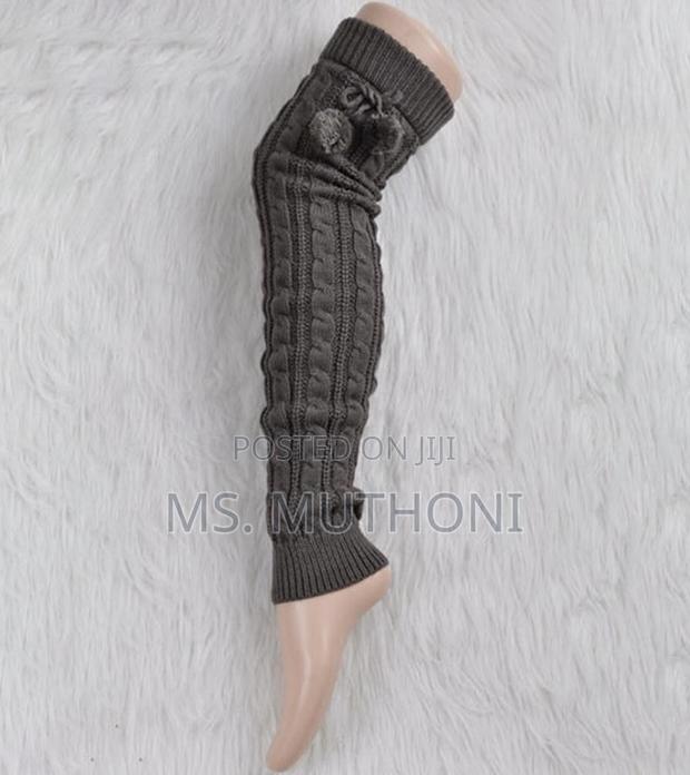 Cable-Knit Leg Warmers Featuring Decorative Pom-Poms and Ribbed Cuffs